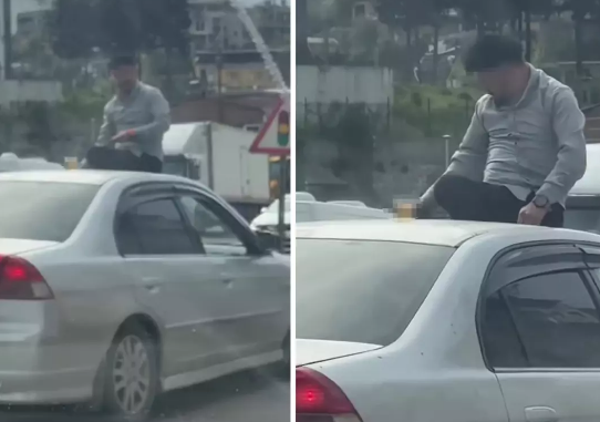Hərəkətdə olan avtomobilin üstündə əyləşərək, spirtli içki qəbul etdi - VİDEO