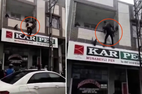 Balkon dəmirlərinə asılı qalan uşağı yoldan keçən qəhrəman xilas etdi - VİDEO